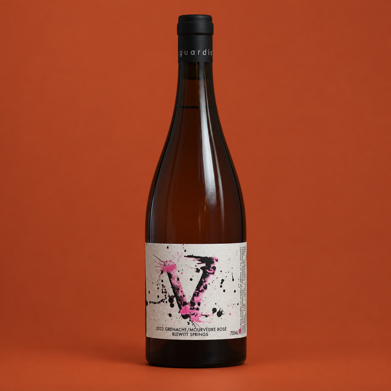 2022 Vanguardist Grenache Mourvèdre Rosé bottle on a burnt orange background