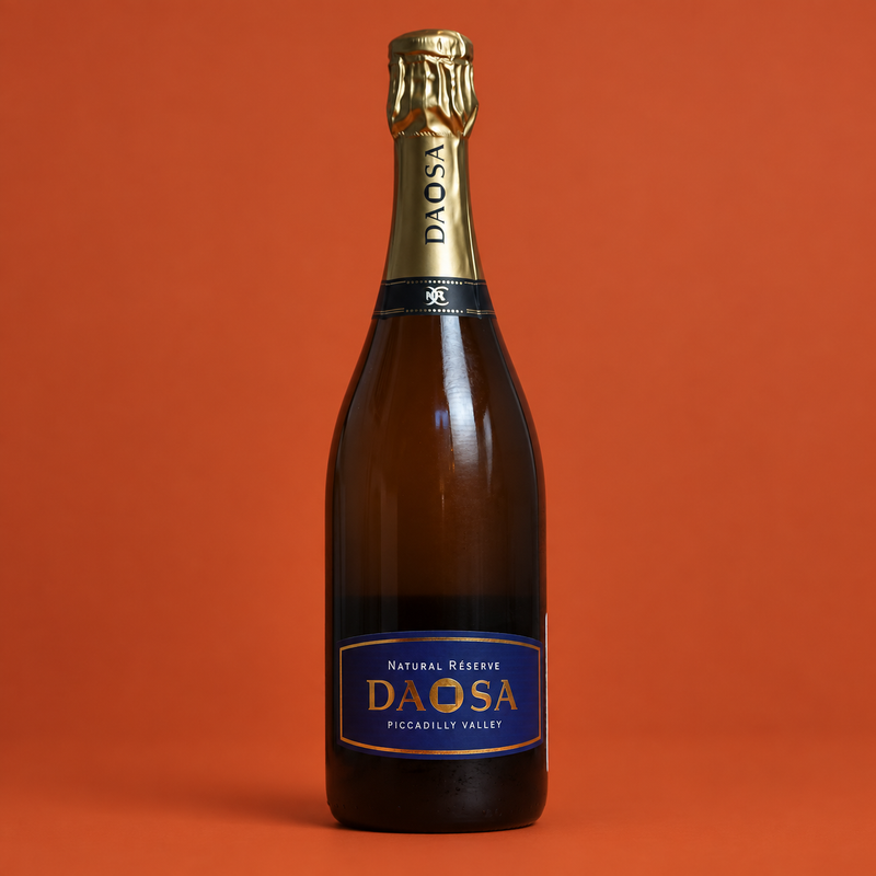 DAOSA Natural Réserve sparkling wine bottle on a burnt orange background